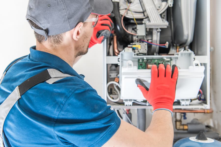 Technician with glasses installing furnace